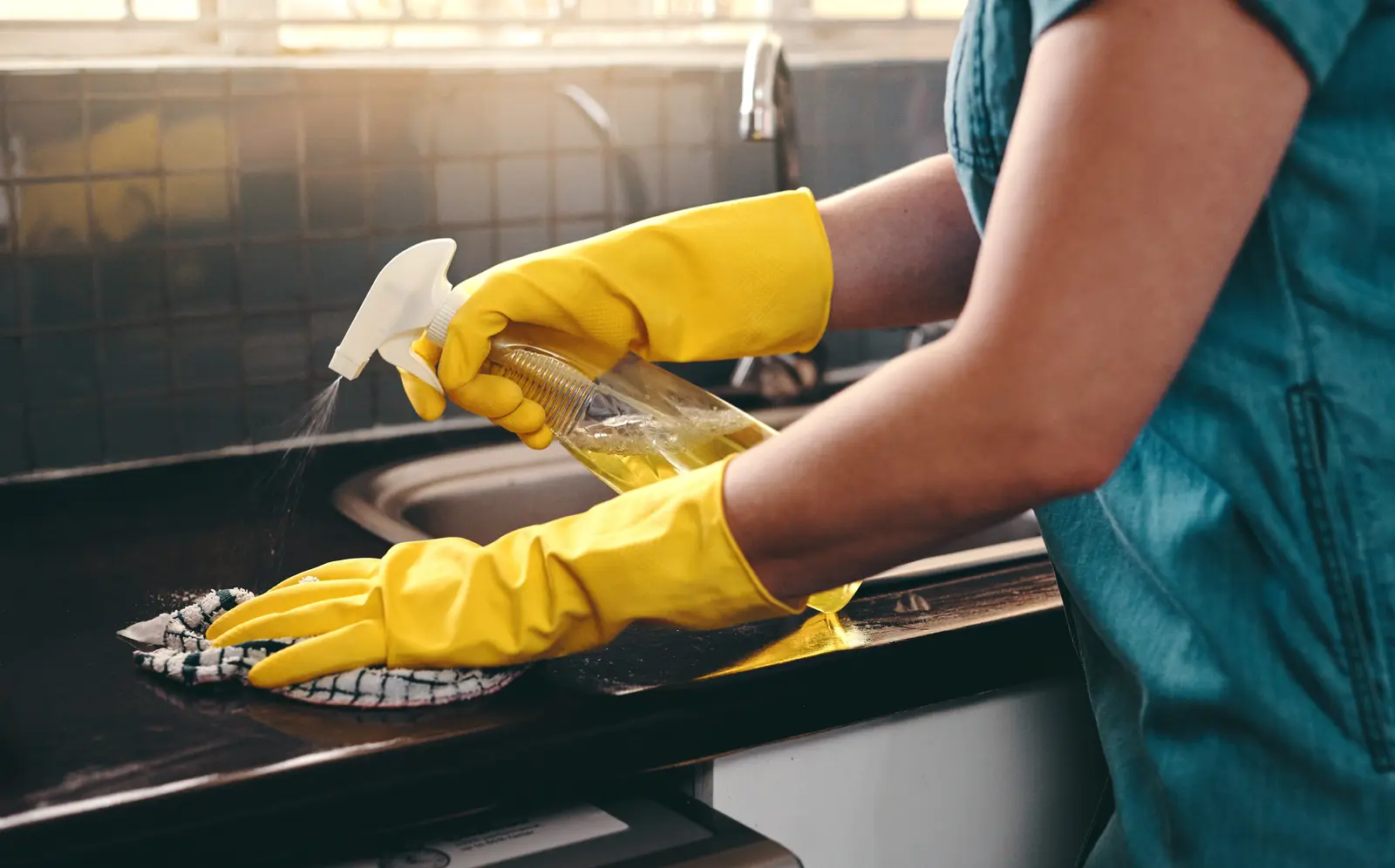 Disinfecting a countertop with spray and cloth